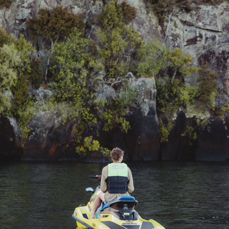 a group of people riding on the back of a boat in the water